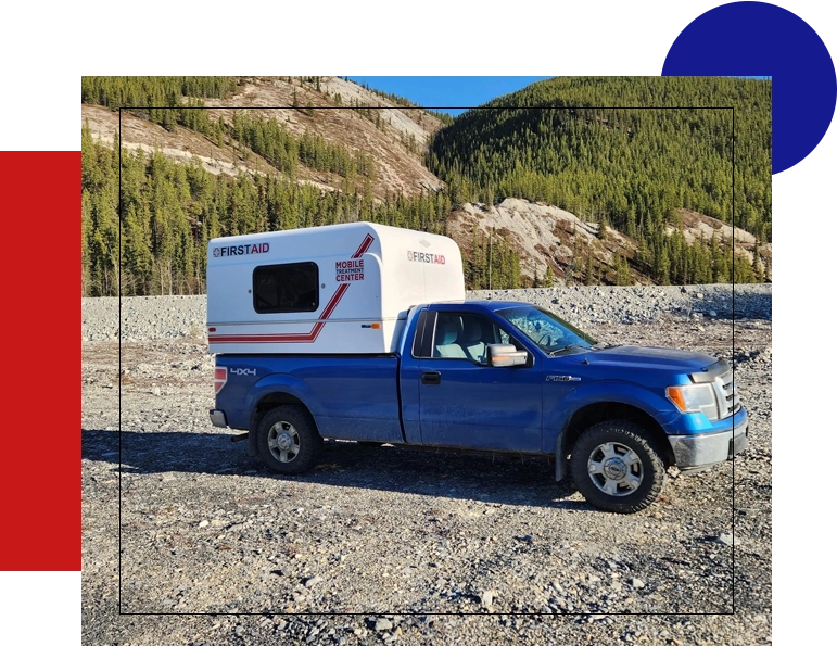 A blue truck with an rv in the back.